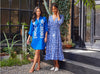 two women models wearing blue dresses